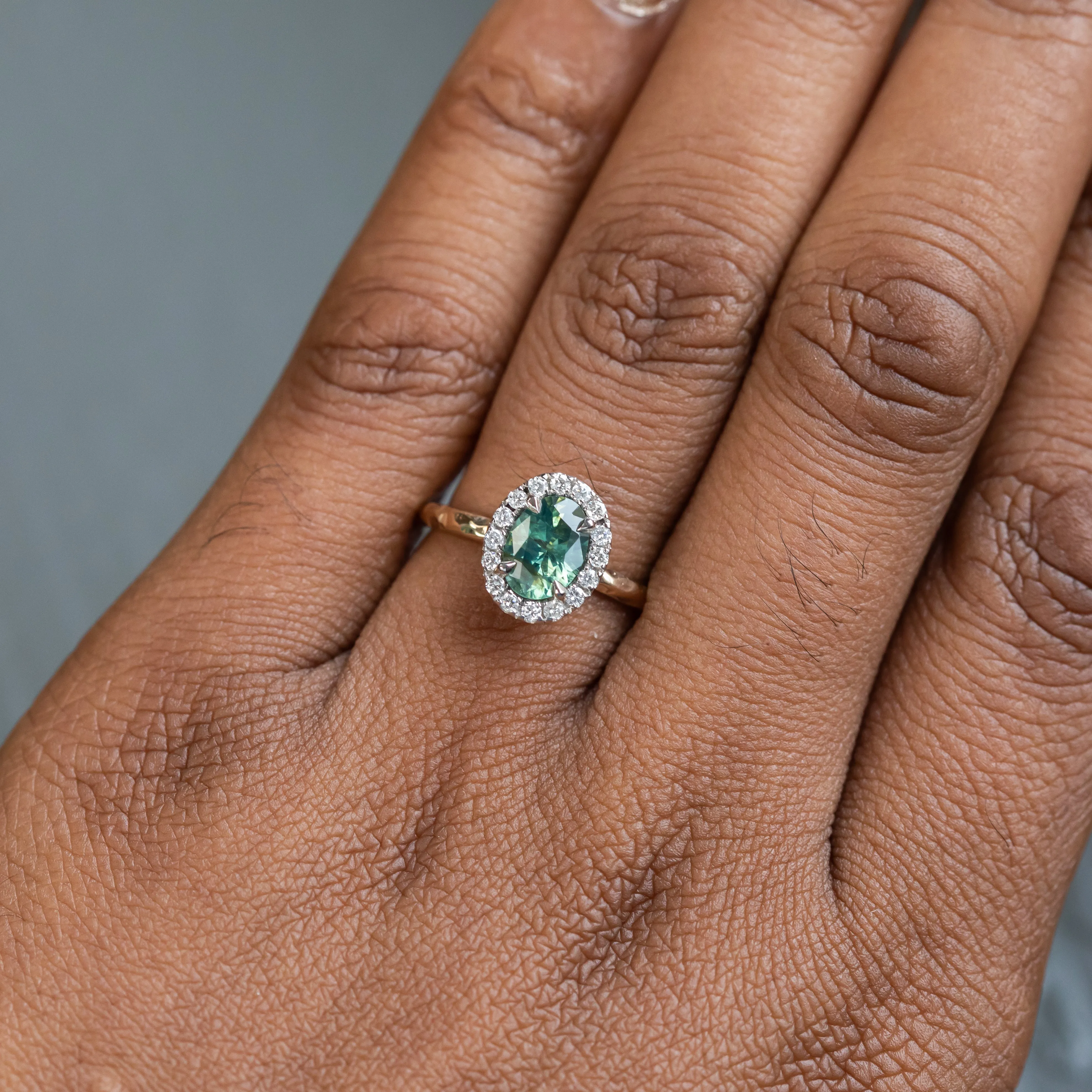 1.20ct Silky Oval Green Madagascar Sapphire and Diamond Four Prong Halo Ring in 14K White Gold Halo and 14k Yellow Gold Shank