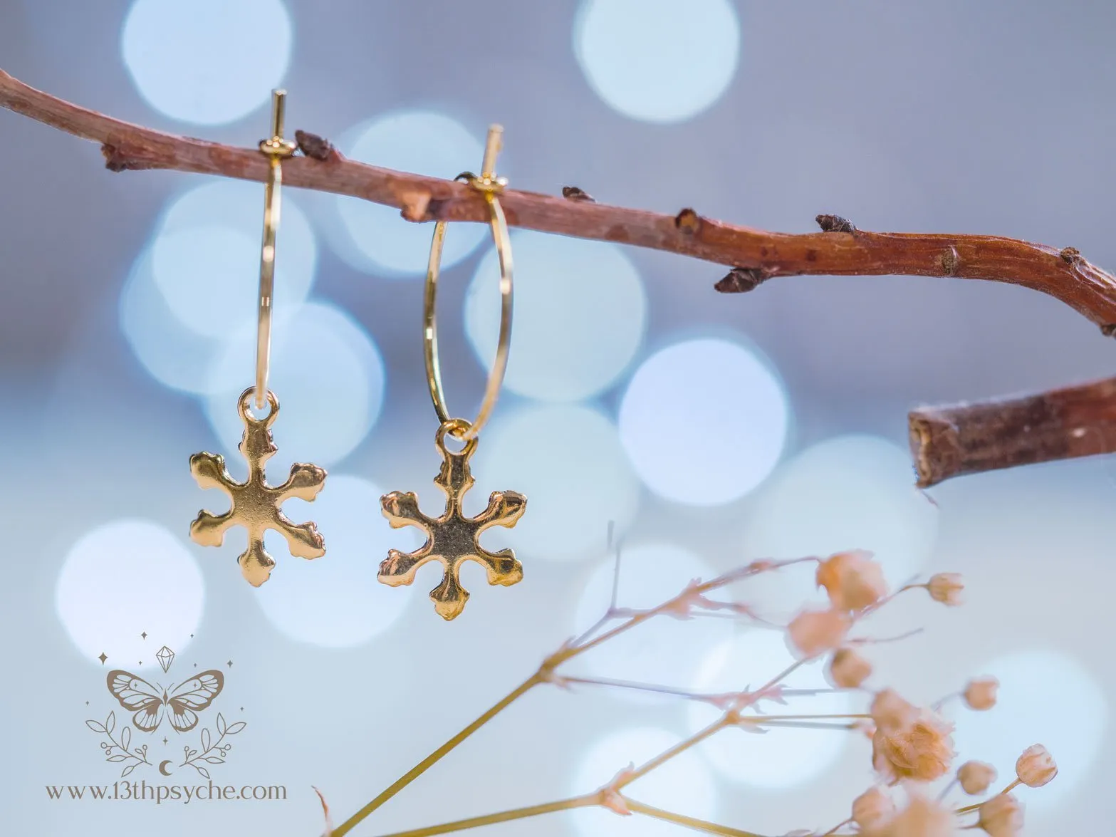 Hypoallergenic gold hoop earrings with snowflake charm