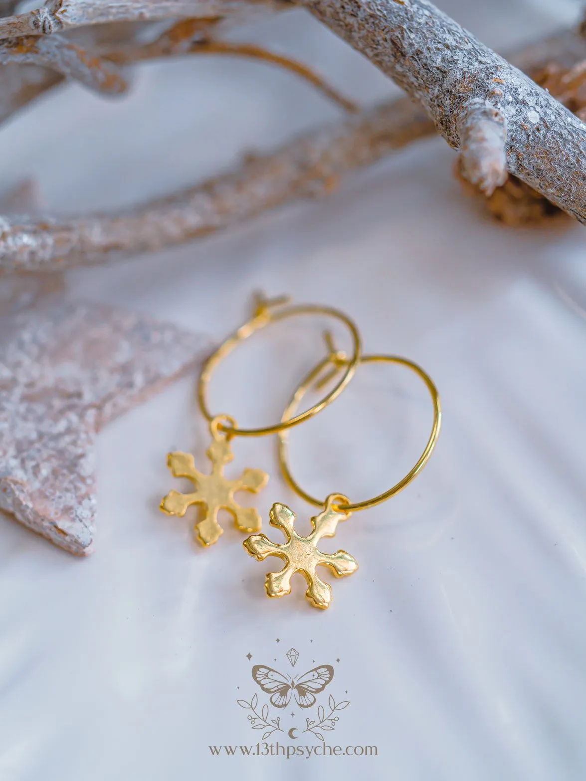 Hypoallergenic gold hoop earrings with snowflake charm